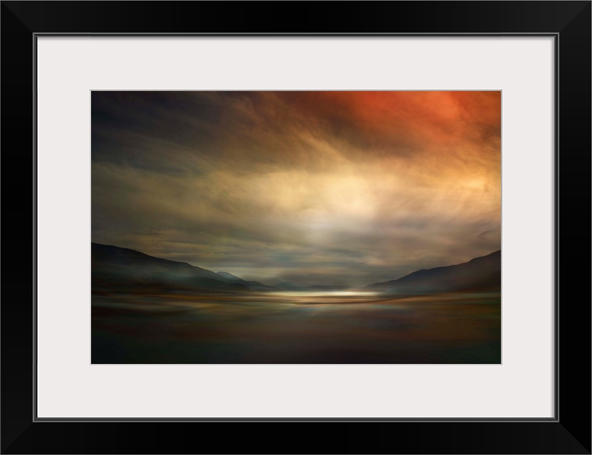 Fine art photo of a valley dimly lit by glowing clouds at sunset in Canada.