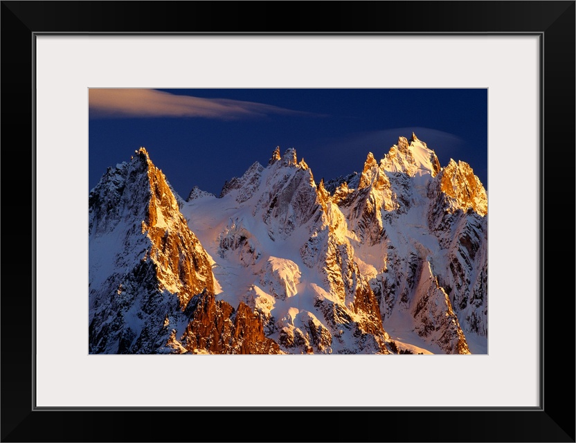 Big photograph taken of snow covered mountains in the Alps of France.