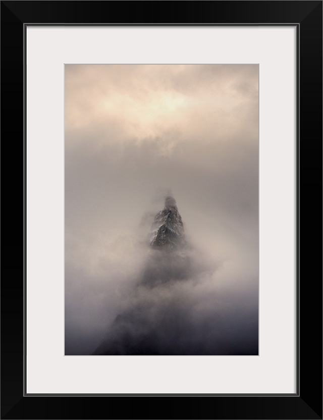 Mountain top, Aiguille des Dru, in the fog in the valley of Chamonix in French Alpes.