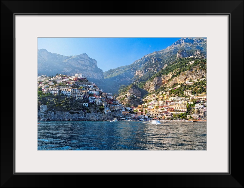 Fine art photo of the Mediterranean town of Positano nestled in the hills, seen from the ocean.