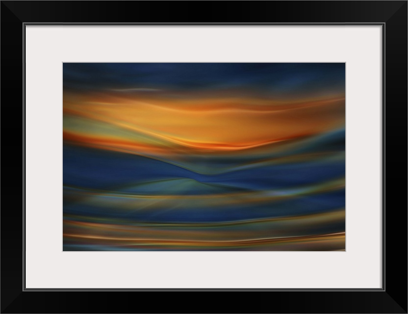 Abstract photograph of blurred and blended colors and flowing lines in shades of orange and blue.