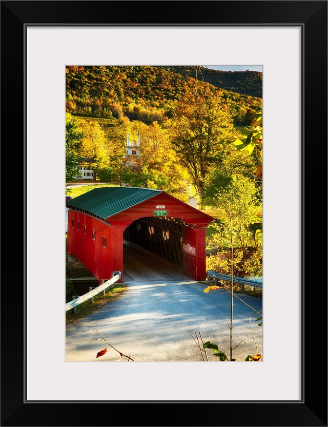 Fine art photo of a red covered bridge in Vermont in the fall.