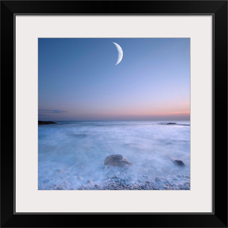 This large art piece highlights a crescent moon with fog cascading over the rocks and water below.