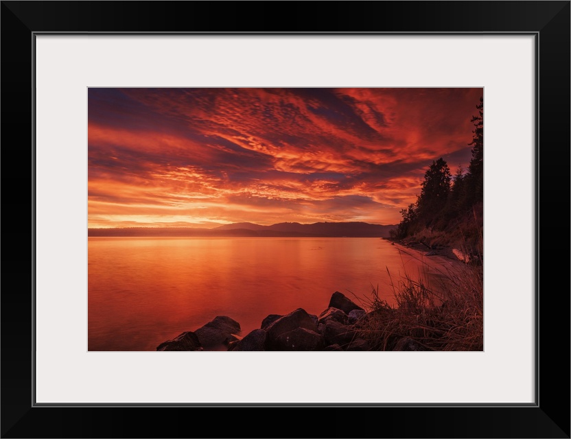 A stunning fiery sky before sunrise at Port Williams Beach in Washington State.