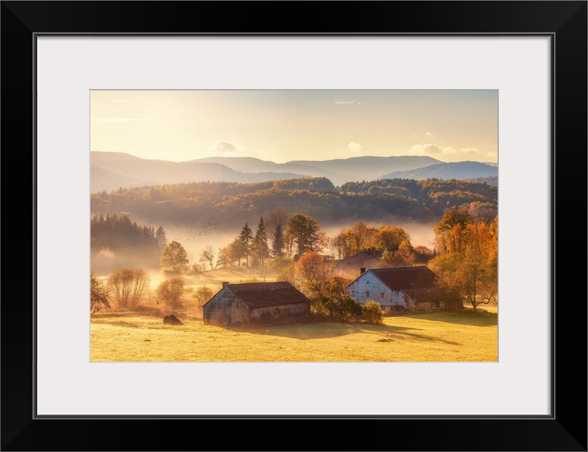 Misty country landscape with farms in the foreground