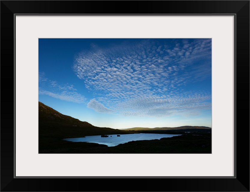 Cloudy blue sky over a lake in Ireland