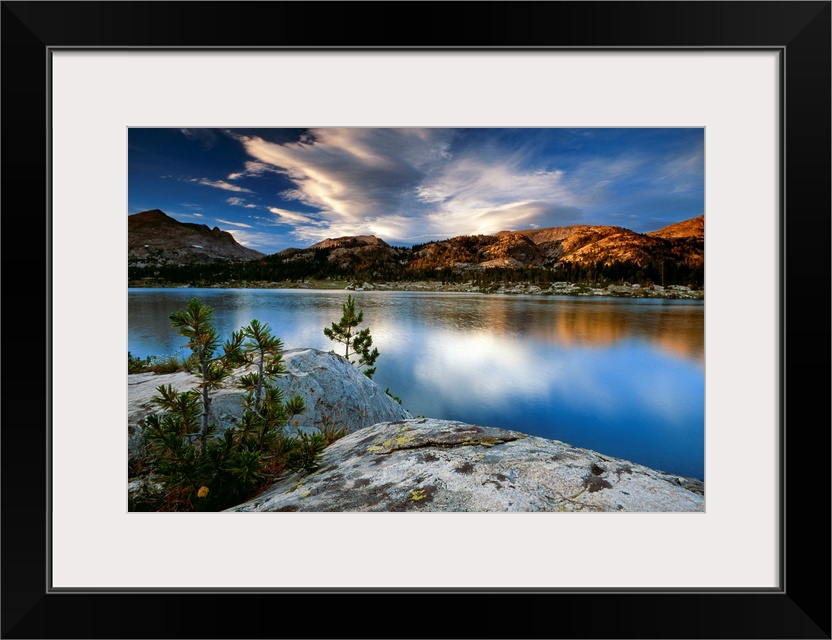 Clouds and mountains reflect in the surface of the still water in this oversized art for the decoration.