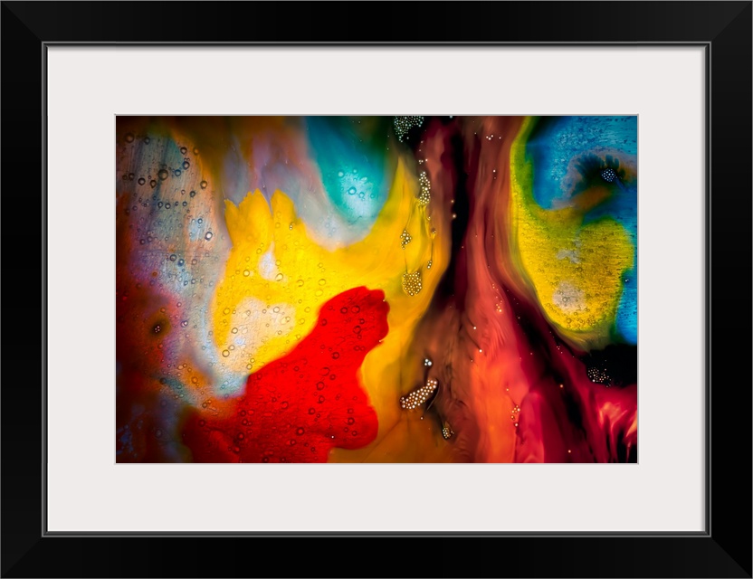 Fine art abstract photograph of swirling paint in bright reds and yellows.
