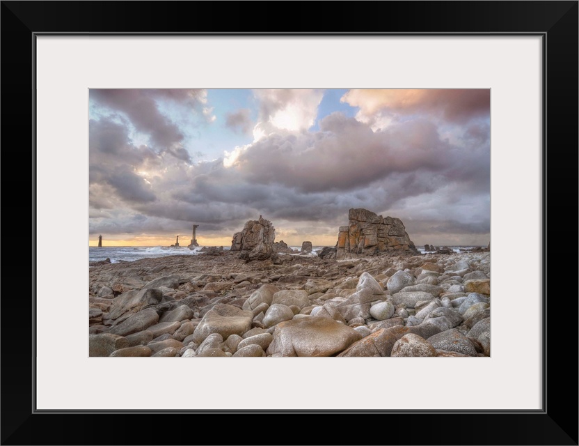 Colored sunset at Pointe de Pern place in Ouessant island in France among rocks.