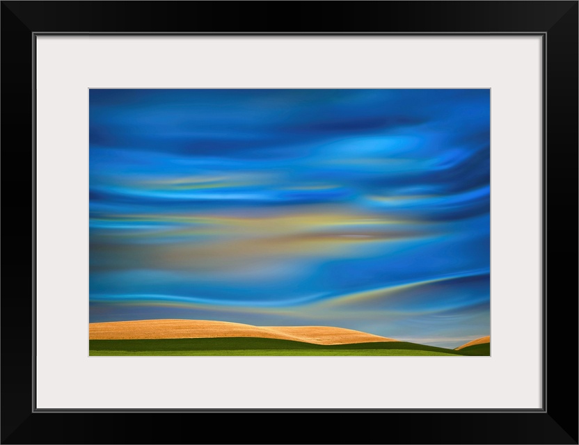 Abstract photograph of the Palouse farmland in Washington state, with a vibrant blue motion blurred sky.