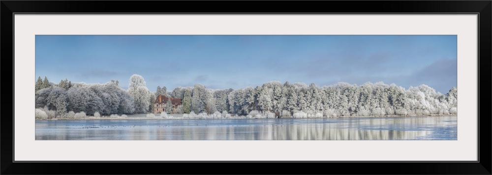 Panoramic photograph of a view across the lake from Broceliande Castle in winter.