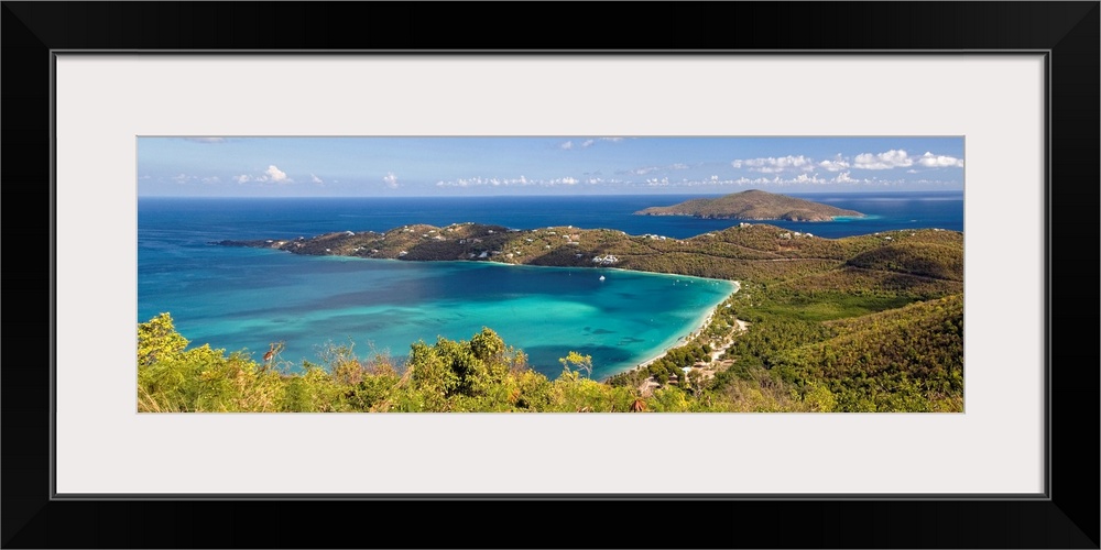 This panoramic photograph is an aerial shot of a bay in the virgin islands surrounded by large hills.