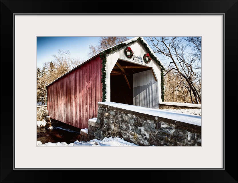 Fine art photo of a covered bridge under a light snowfall.