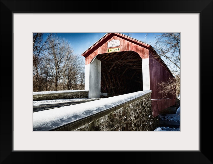 Fine art photo of a covered bridge under a light snowfall.