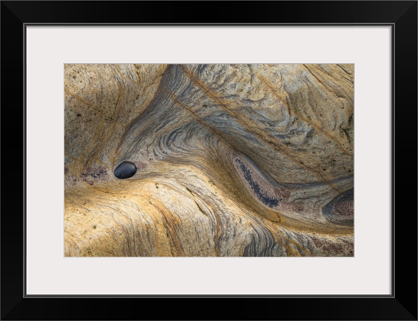 Abstract photograph of a rocky surface displaying all its layers of age and experience.