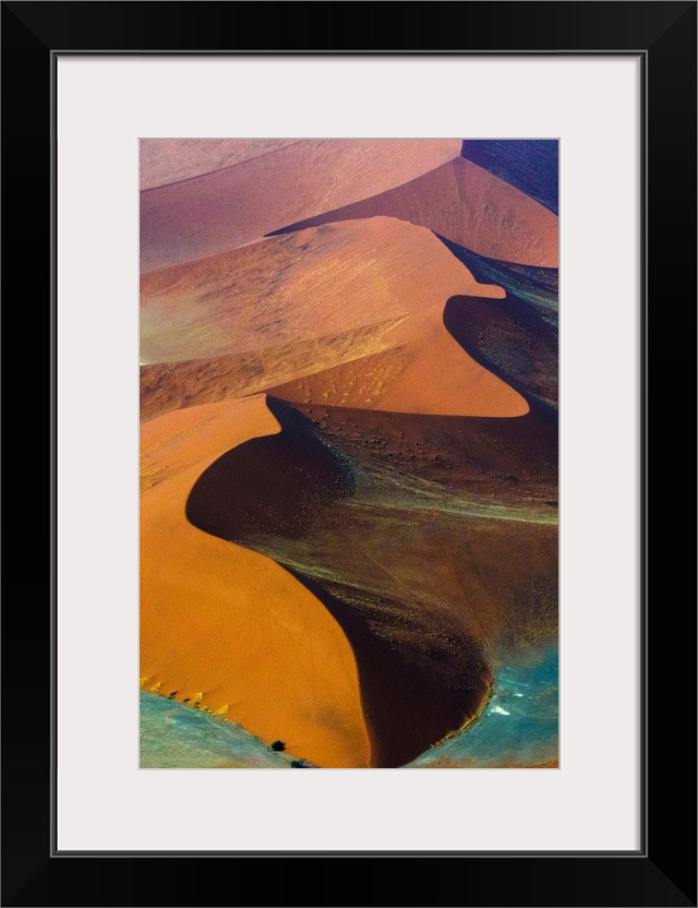 Fine art photo of giant sand dunes of varying colors in Namib-Naukluft National Park, Namibia.