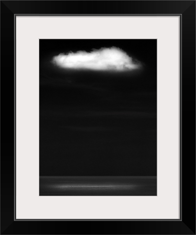 A zen-like monochrome black and white seascape with a flat calm sea and a single white fluffy cloud with silver light on t...