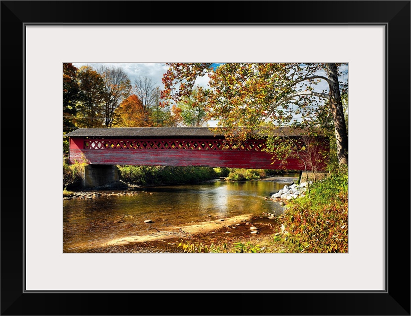 Fine art photo of a historic covered bridge over the Waloomsac River in New England.