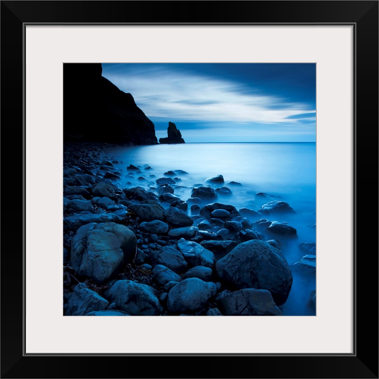 This is a vertical landscape photograph of fog and water on rocky beach that would make great huge wall art for the home o...