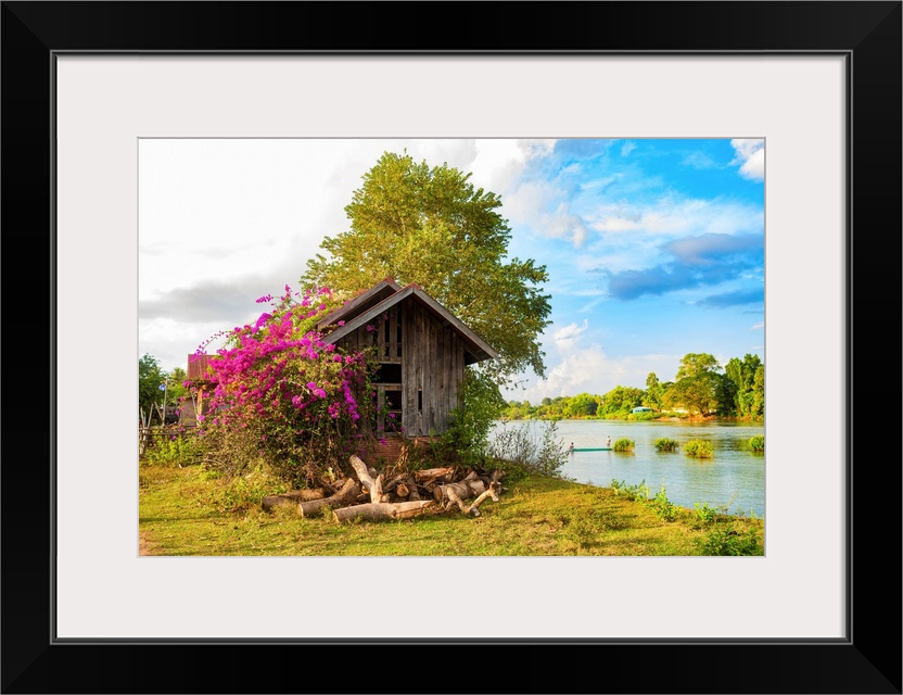 A hut with a bougainvillea in an Asian landscape