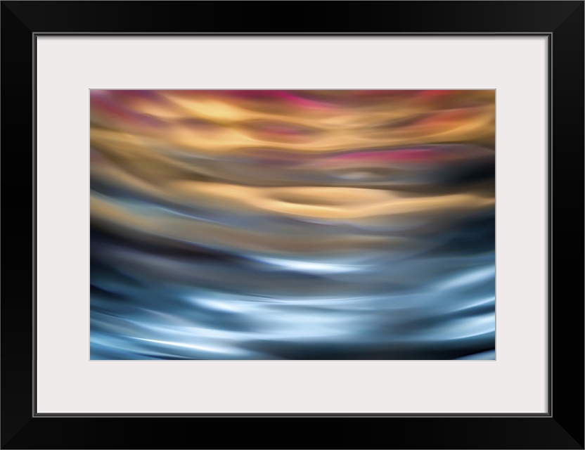 Abstract photograph in orange and blue shades resembling ocean waves.