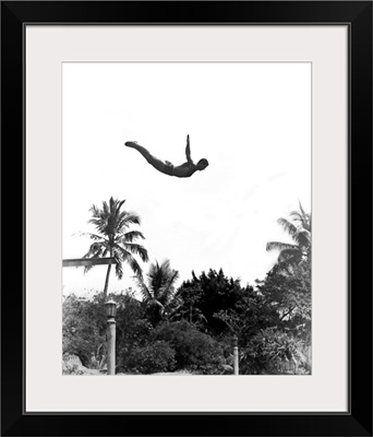 1940's Man Poised Midair Jumping From Diving Board Into Pool