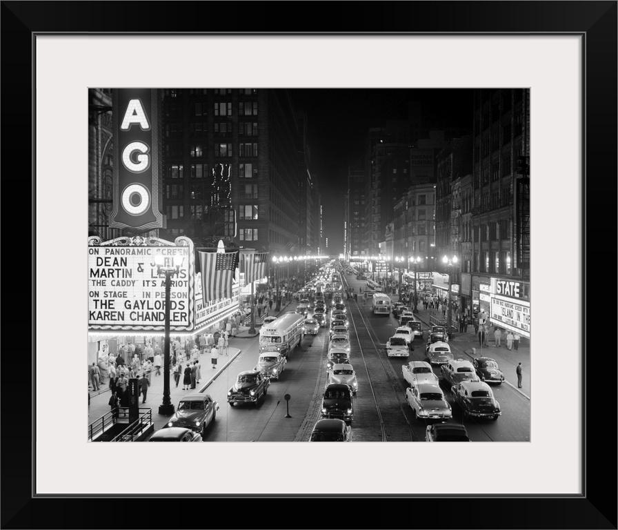 1950's 1953 Night Scene Of Chicago State Street With Traffic And Movie Marquee With Pedestrians On The Sidewalks.