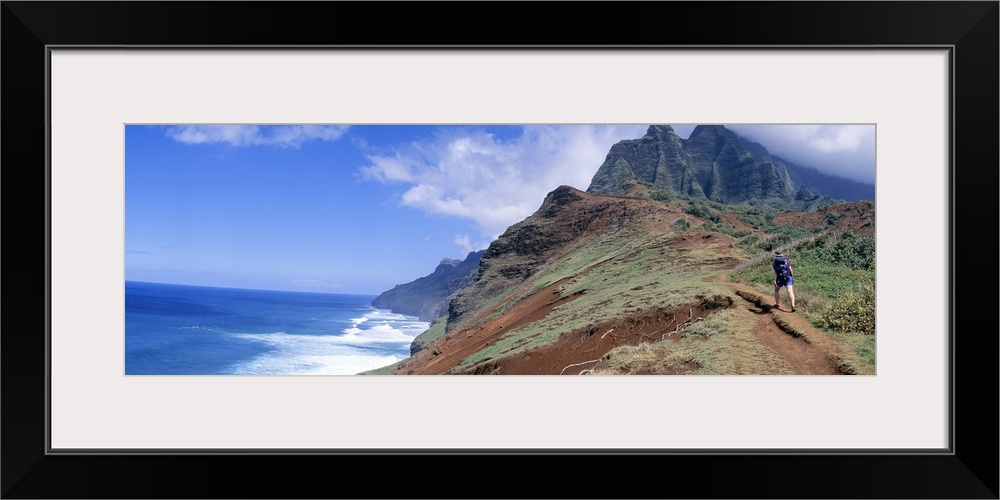 Adult hiking up a mountain, Kalalau Trail , Na Pali Coast, Kauai, Hawaiis