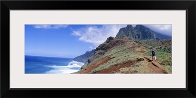 Adult hiking up a mountain, Kalalau Trail , Na Pali Coast, Kauai, Hawaiis