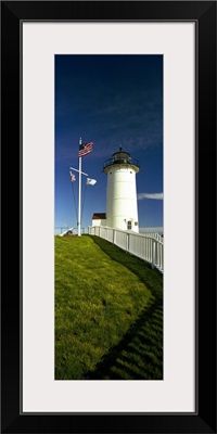 American flags near a lighthouse, Nobska Light, Woods Hole, Cape Cod, Barnstable County, Massachusetts