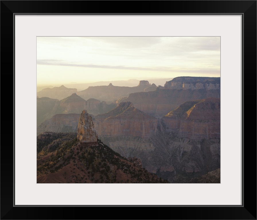 Landscape photograph on a large canvas looking over the vast mountain range in Grand Canyon National Park, as the sun sets...