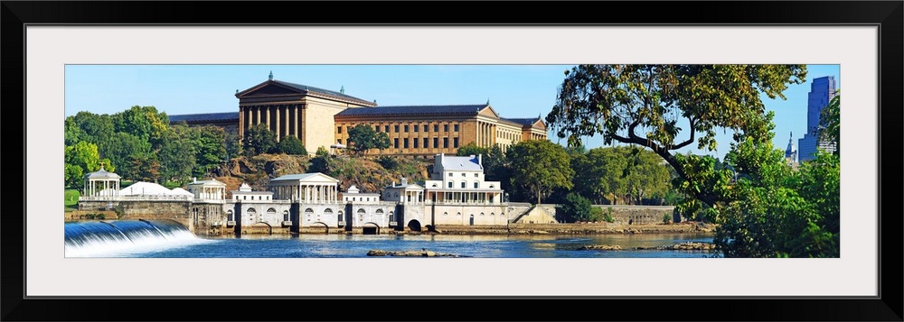 Wall docor of an art museum in Philadelphia by the water with a waterfall flowing on the left.