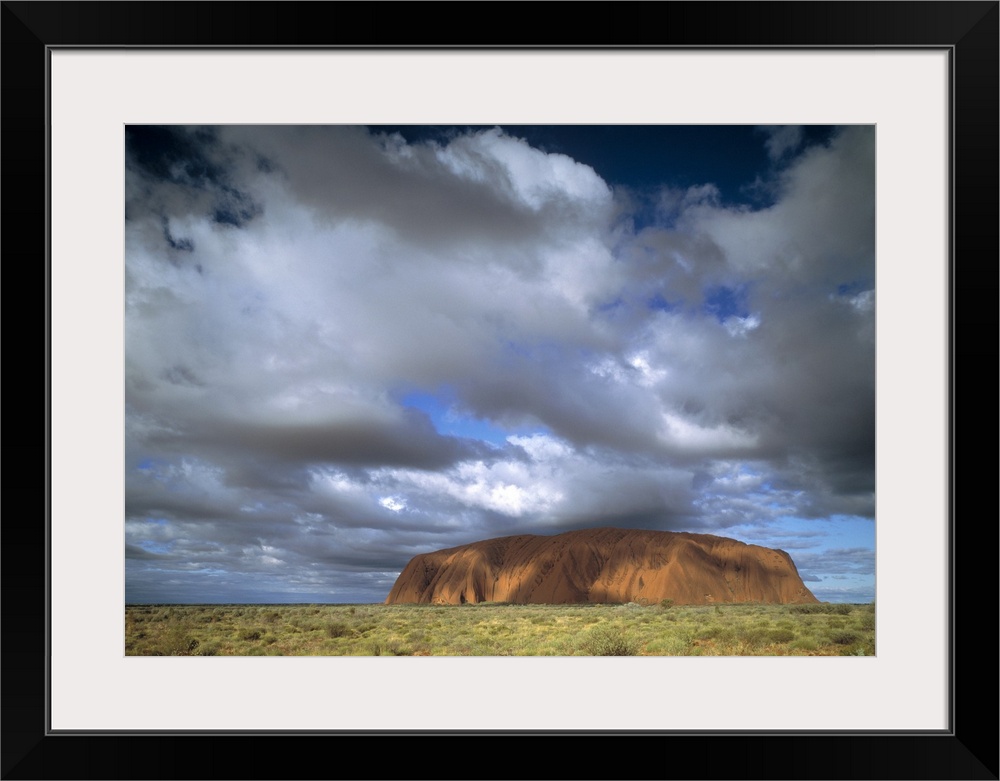 This is a landscape photograph of the mountain island landmark in the outback under growing cloud cover.