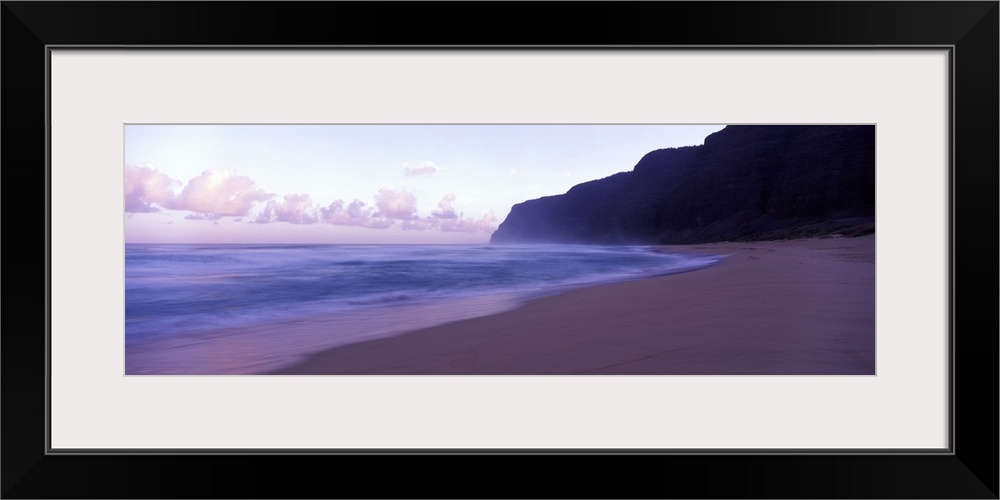 Serene panoramic photograph of a Hawaii beach at dusk in soft cooler tones.