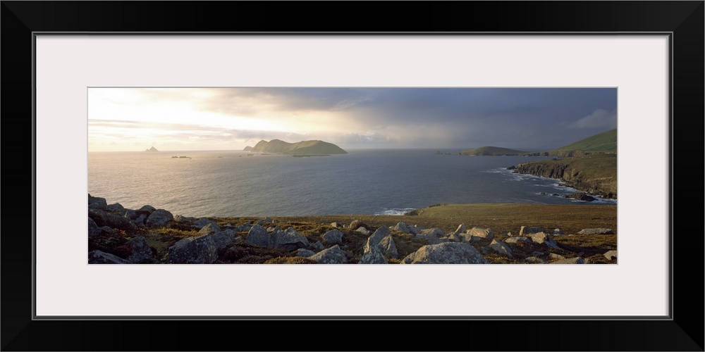 This is a panoramic photograph of the view over a rocky sea cliff and the Atlantic Ocean beyond.