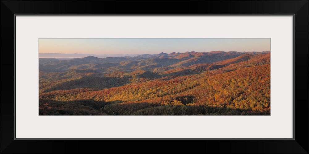 Panorama of sunlight falling on the rolling hills along the Blue Ridge Parkway in North Carolina.