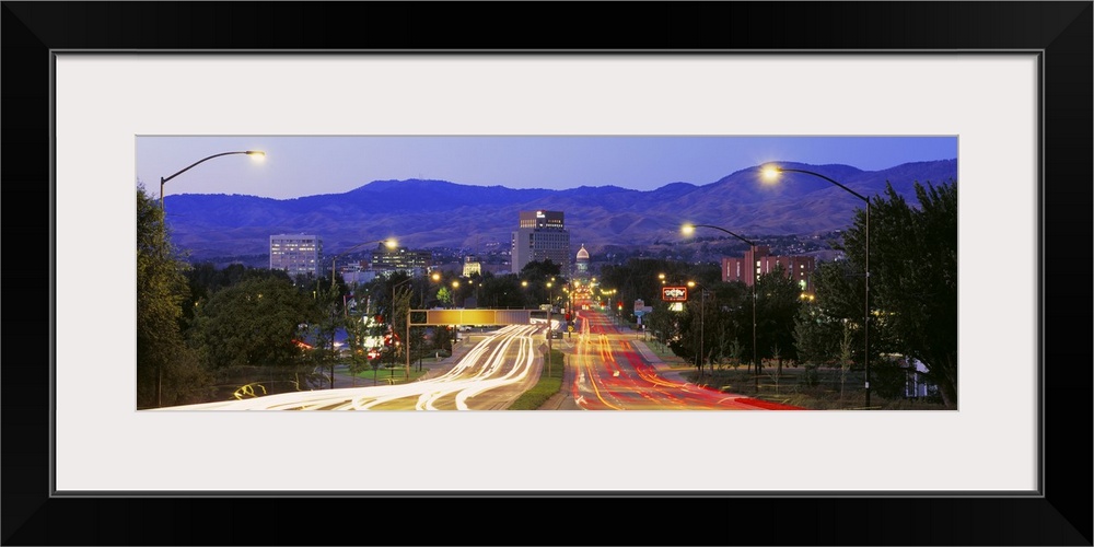 Panoramic photograph taken of a major highway in Boise with the lights of the cars shown as streaks on the road.