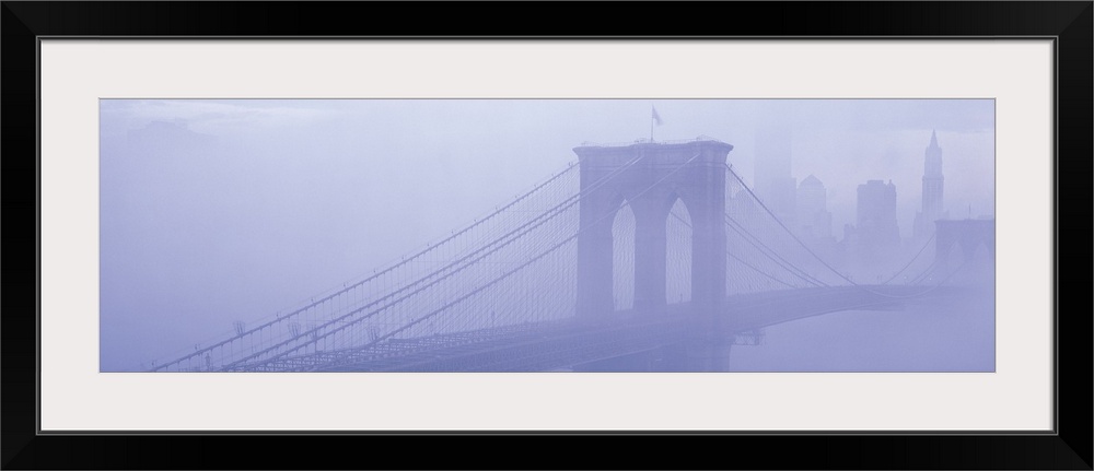 Panoramic photograph on a giant wall hanging of fog surrounding New York's famous Brooklyn Bridge.  Part of the New York C...