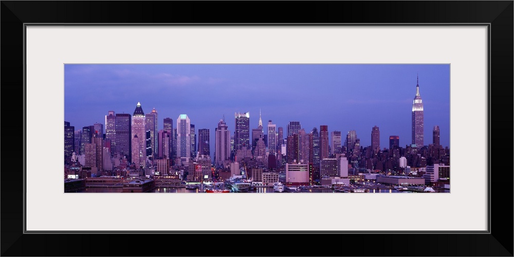 This panoramic photograph was taken at dusk of the Manhattan skyline from across the water.