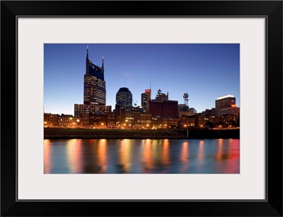 Buildings lit up at dusk at the waterfront, Cumberland River, Bell South Tower, Nashville, Tennessee