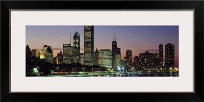 Buildings lit up at dusk, Lake Michigan, Chicago, Cook County, Illinois