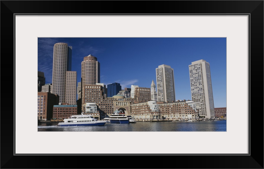 Wall docor of buildings in Boston on the water with a boat passing by.