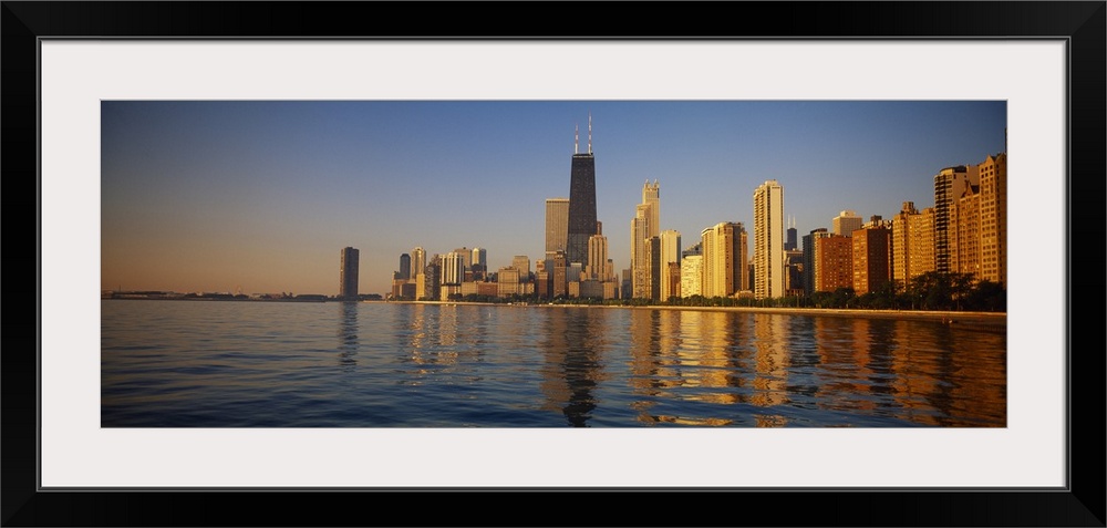 Long horizontal photo of the skyline of Chicago meeting the water front at sunset printed onto canvas.