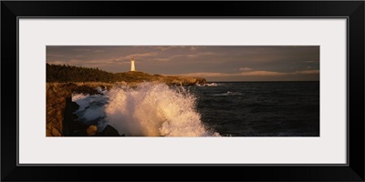 Canada, Nova Scotia, Cape Breton Island, Waves breaking on the rocks near Louisbourg lighthouse