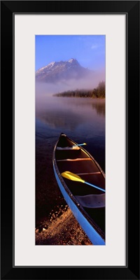 Canoe in lake in front of mountains, Leigh Lake, Rockchuck Peak, Teton Range, Grand Teton National Park, Wyoming