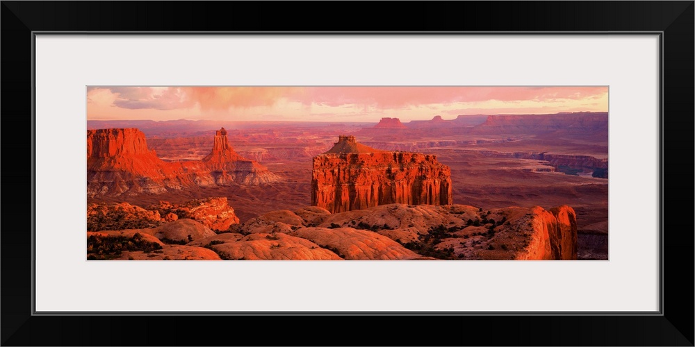 Giant panoramic photo of the Canyonlands National Park in Utah (UT) with peaks and valleys as far as the eye can see. Warm...