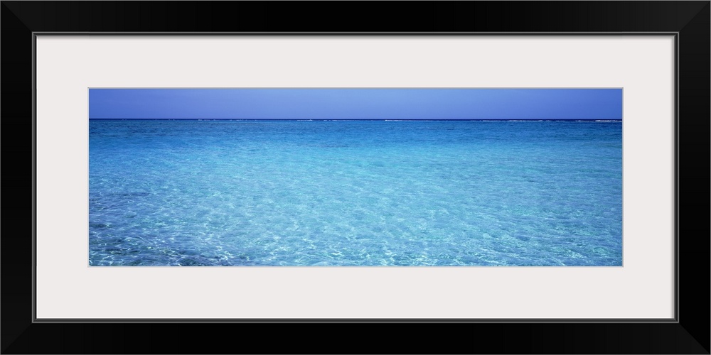 Long panoramic photo print of crystal clear ocean water in the Caribbean.