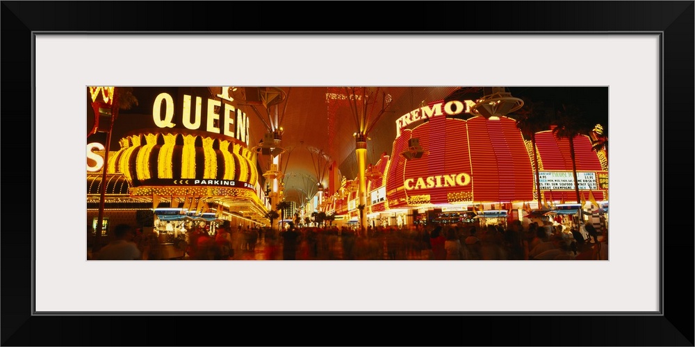 Wide angle photograph on a giant canvas of the casinos with bright lights at night, along Fremont Street in downtown Las V...