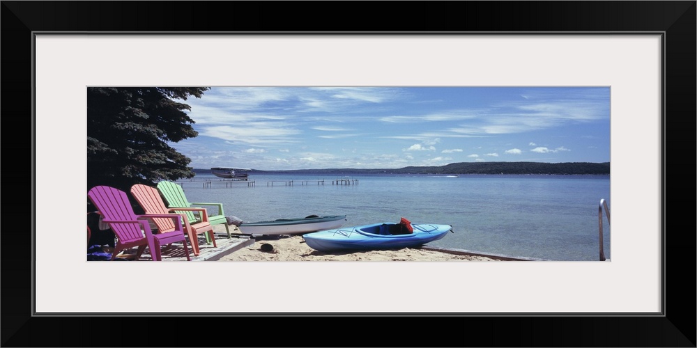 Chairs and boats at the lakeside Crystal Lake Frankfort Benzie County Michigan