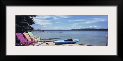 Chairs and boats at the lakeside Crystal Lake Frankfort Benzie County Michigan